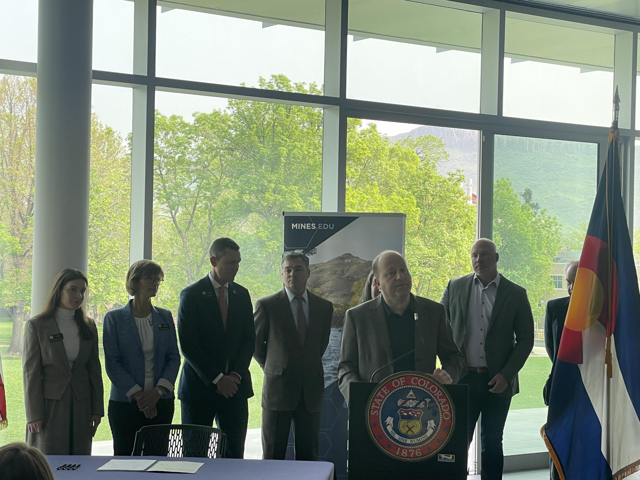 (Caption: Gov. Polis signs SB23-285 at the Colorado School Of Mines campus on May 22, 2023)