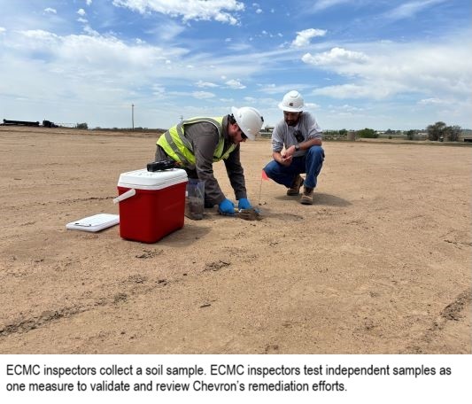 Two ECMC Inspectors kneel near a red cooler while collecting a soil sample