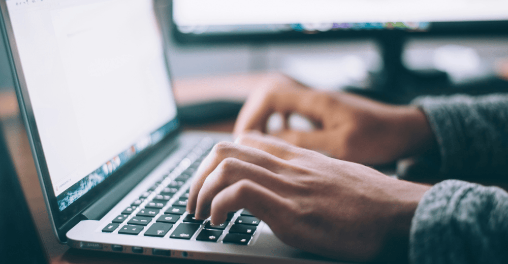 Person typing on a laptop.