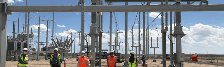 Workers standing in front of rig